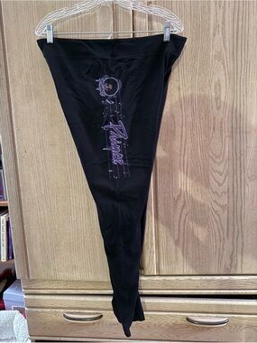 Xlusion Black leggings with Prince’s name and symbol written in purple.